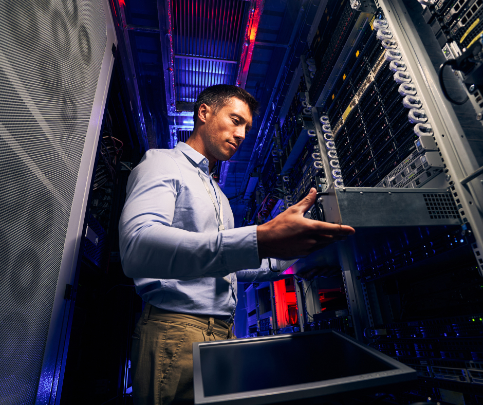 “A technician performing UPS system service and maintenance inside a data center, inspecting and installing equipment in a server rack