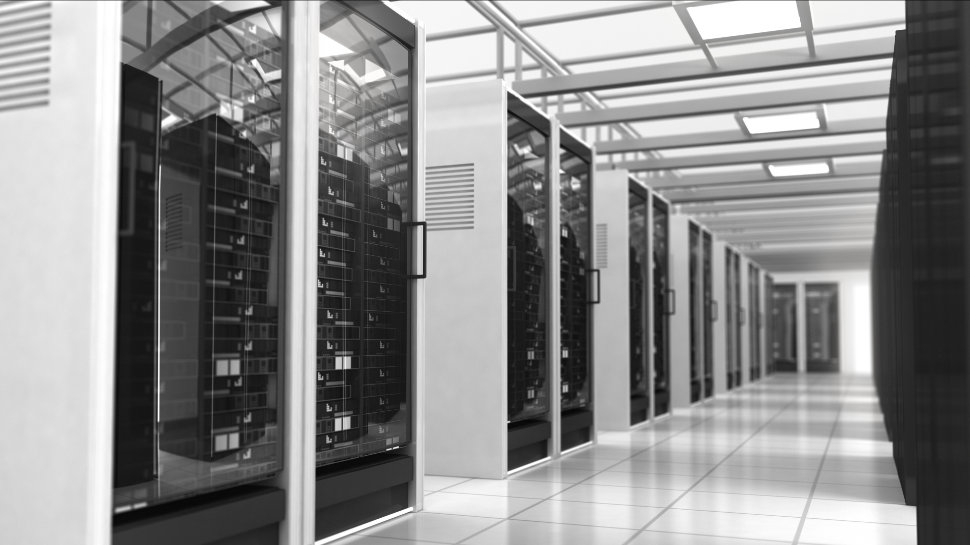 A black and white photograph of an aisle in a data center, showing rows of tall server racks in white and black enclosures extending into the distance. UPS system